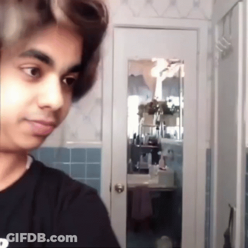 Young Man With Curlers In Bathroom Mirror GIF