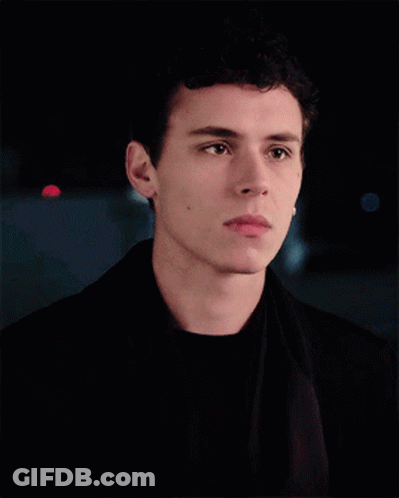 A Young Man With Curly Hair Is Wearing A Black Jacket GIF