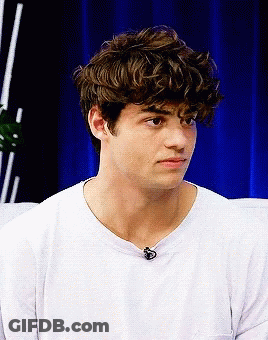 A Young Man With Curly Hair Wearing A White T-Shirt GIF