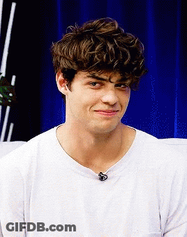 A Young Man With Curly Hair Wearing A White T-Shirt GIF