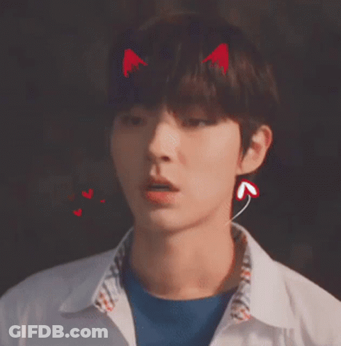 A Young Man With Devil Horns On His Head Wearing Ear Buds . GIF