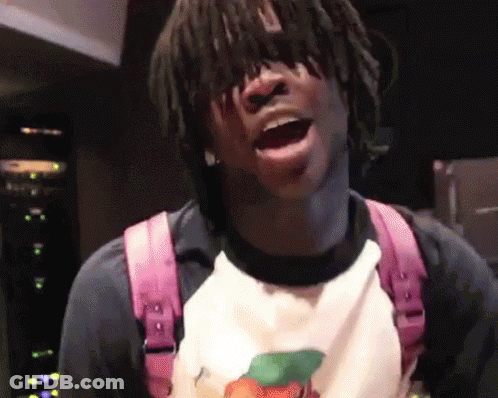 A Young Man With Dreadlocks Is Wearing A Pink Backpack And A White Shirt GIF