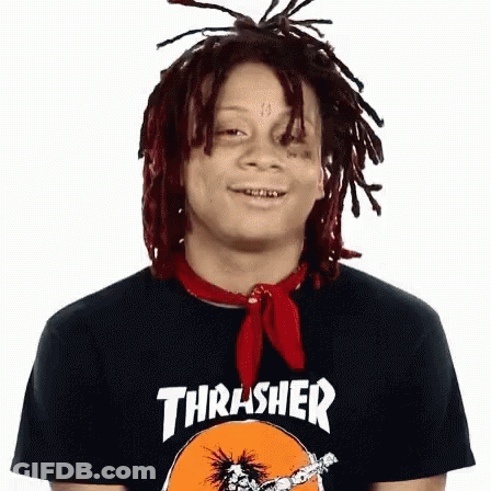 A Young Man With Dreadlocks Is Wearing A Thrasher Shirt And A Red Scarf Around His Neck . GIF