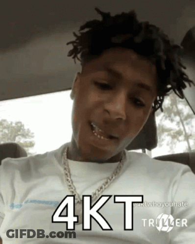 A Young Man With Dreadlocks Is Wearing A White Shirt And A Chain Around His Neck And Says 4Kt GIF