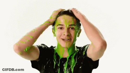 A Young Man With Green Slime On His Face Is Holding His Head GIF
