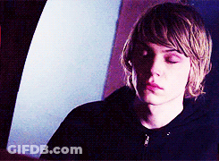 A Young Man With His Eyes Closed Is Wearing A Black Jacket GIF