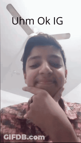 A Young Man With His Hand On His Chin And The Words Uhm Ok Ig Written Above Him GIF