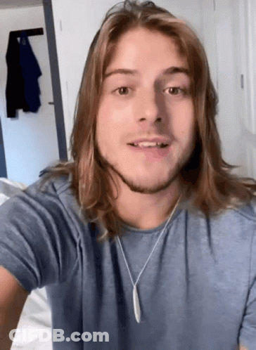 Young Man With Long Hair And Blue Shirt GIF