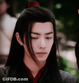 A Young Man With Long Hair Has A Red Ponytail GIF