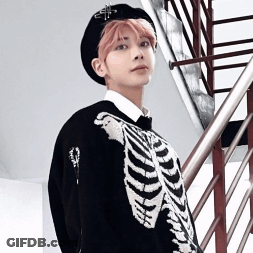 A Young Man With Pink Hair Is Wearing A Skeleton Sweater GIF
