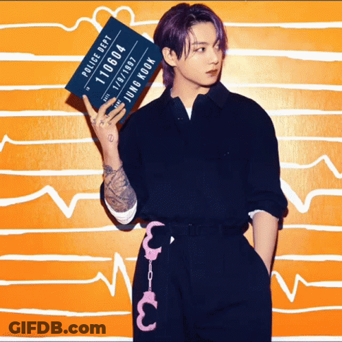 A Young Man With Purple Hair Is Holding Up A Police Department Mug Shot GIF