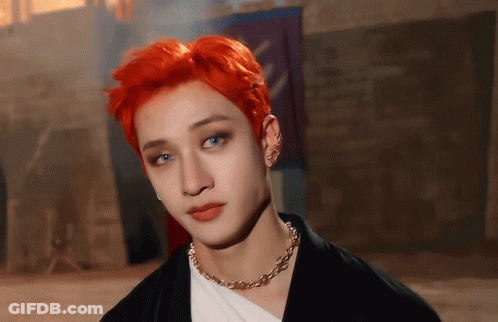 A Young Man With Red Hair And Blue Eyes Wearing A Necklace GIF