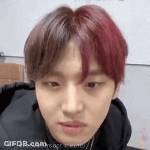 A Young Man With Red Hair Is Looking At The Camera . GIF