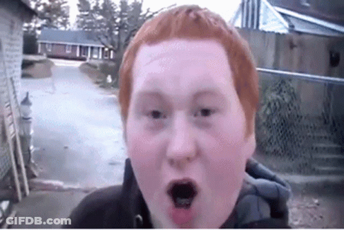 A Young Man With Red Hair Is Making A Funny Face GIF