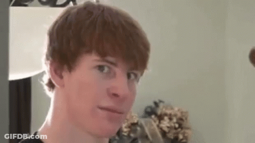 A Young Man With Red Hair Is Making A Funny Face While Looking At The Camera . GIF