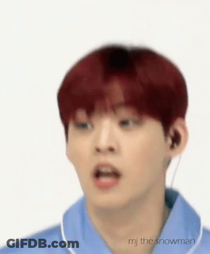 A Young Man With Red Hair Is Wearing A Blue Shirt And Earphones . GIF