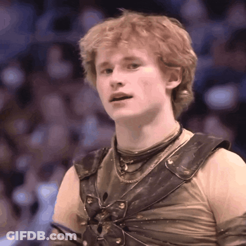 A Young Man With Red Hair Is Wearing A Costume With A Butterfly On It GIF