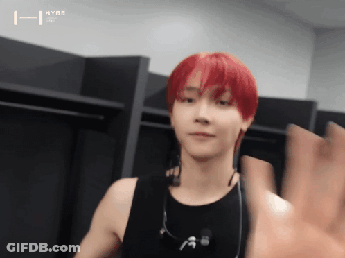 A Young Man With Red Hair Is Wearing Headphones And A Black Tank Top GIF