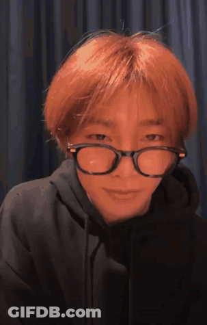 A Young Man With Red Hair Wearing Glasses And A Black Hoodie . GIF