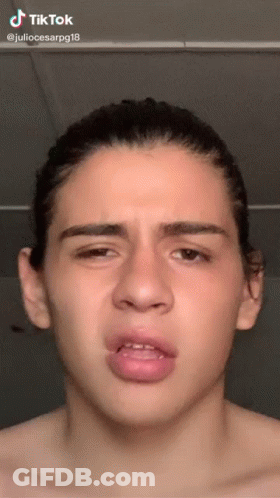 A Young Man Without A Shirt Is Making A Funny Face With A Tik Tok Watermark GIF