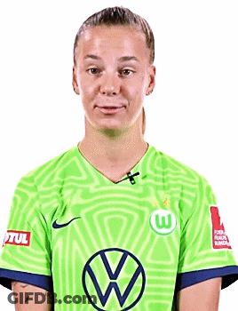 A Young Woman Wearing A Green Soccer Jersey With A Vw Logo On It . GIF