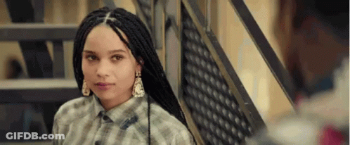 A Young Woman With Braids Is Standing Next To A Set Of Stairs . GIF