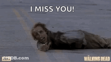 A Zombie Is Laying On The Ground With The Words `` I Miss You '' Written Above Him . GIF