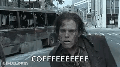 A Zombie Is Running Down A City Street With A Bus In The Background And Says `` Coffee '' . GIF