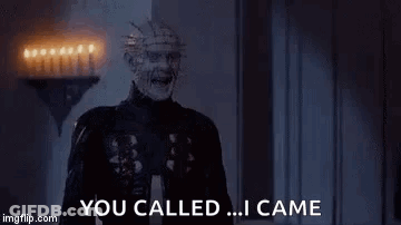 A Zombie Is Screaming And Saying `` You Called ... I Came '' While Standing In A Dark Room . GIF