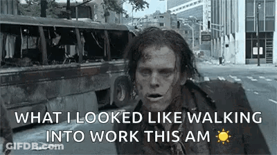 A Zombie Is Walking Down A Street In A City . GIF