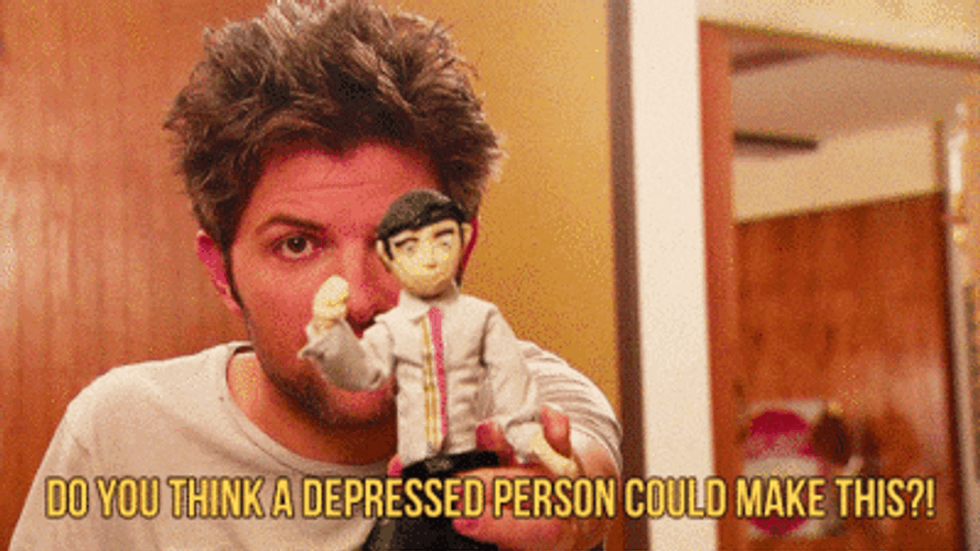 Adam Scott Holding A Toy GIF
