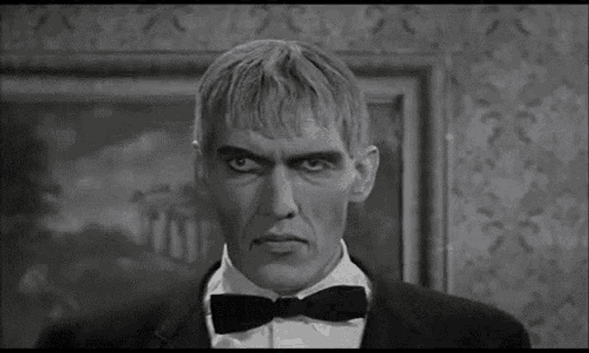 Adams Family Lurch Smirk GIF