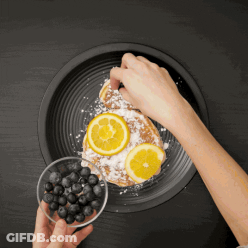 Adding Powdered Sugar To Blueberry Lemon Pancake GIF