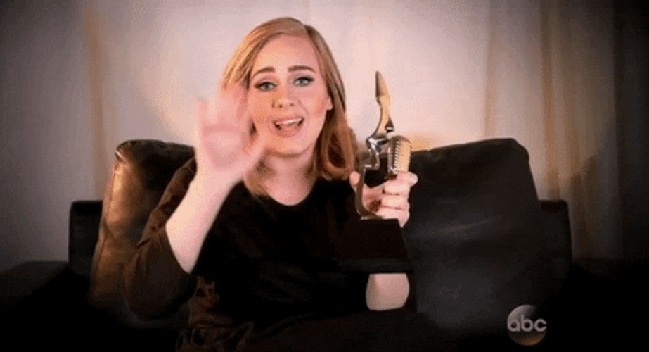 Adele Waving Hi While Holding Trophy GIF