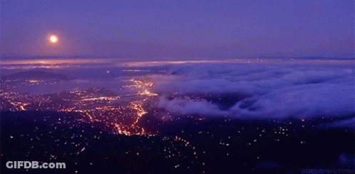 Aerial View City At Night With Full Moon GIF