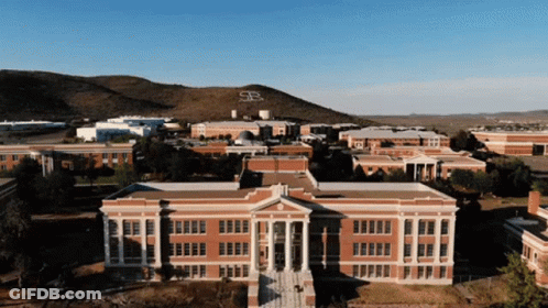 Aerial View Of Brick Building With Mountain And Letter S GIF