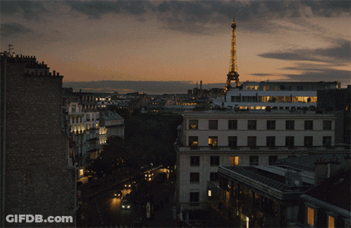 Aerial View Of City At Night With Eiffel Tower Lit Up GIF