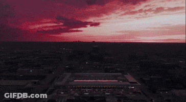 Aerial View Of City At Night With Red Sky GIF
