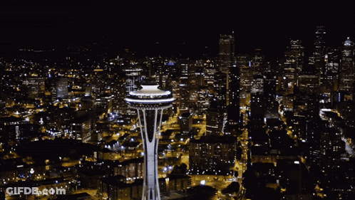 Aerial View Of City At Night With Space Needle Lit Up GIF