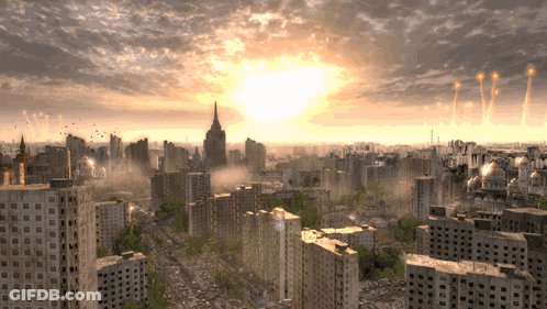 Aerial View Of City At Sunset With Sun Through Clouds GIF