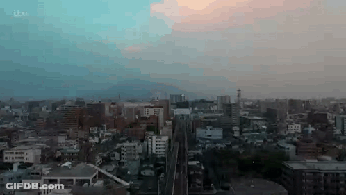 Aerial View Of City At Sunset With Train GIF