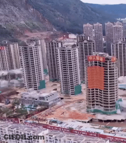 Aerial View Of City With Tall Buildings And Chinese Sign GIF