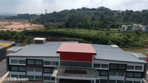 Aerial View Of Large Building With Red And Black Roof GIF