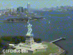 Aerial View Of Statue Of Liberty With City Background GIF