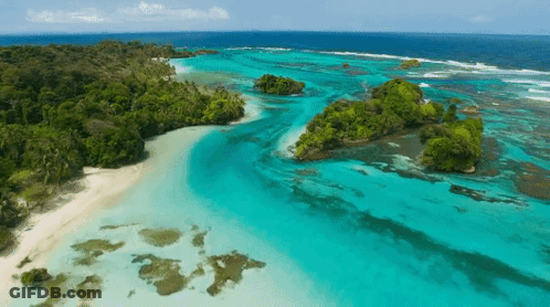 Aerial View Of Tropical Island With White Sandy Beach GIF