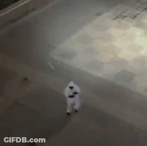 Aerial View Person In White Suit Walking Down Street GIF