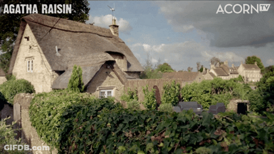 Agatha Raisin Stalking Behind Fence GIF
