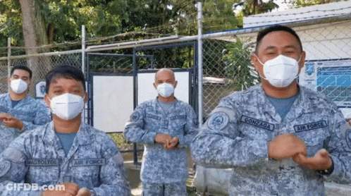 Air Force Soldiers In Face Masks At Chain Link Fence GIF