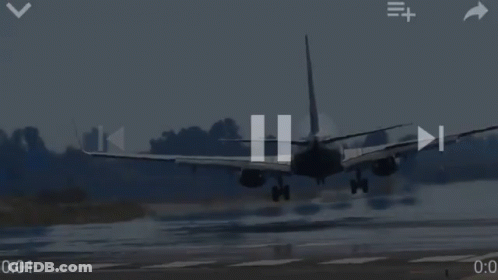 Airplane Landing On Wet Runway With Trees GIF