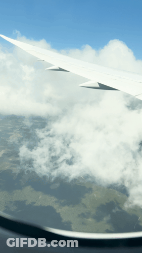 Airplane Wing Flying Through Clouds GIF